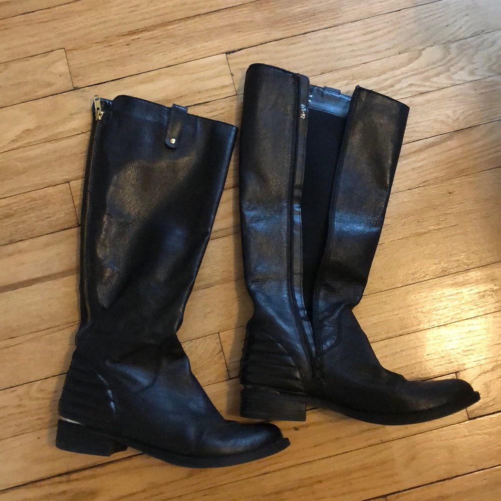 Black leather knee high boots.